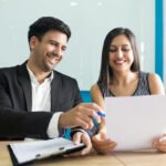 positive business executives laughing while reading contract 1262 18019 (1)