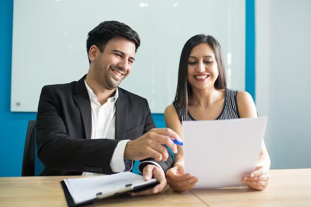 positive business executives laughing while reading contract 1262 18019 (1)