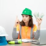 worker female orange vest green helmet sitting desk high quality photo 2831 9719