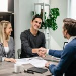 young happy couple making agreement with their financial advisor home men are shaking hands 637285 3839