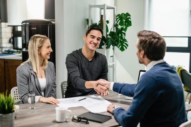 young happy couple making agreement with their financial advisor home men are shaking hands 637285 3839